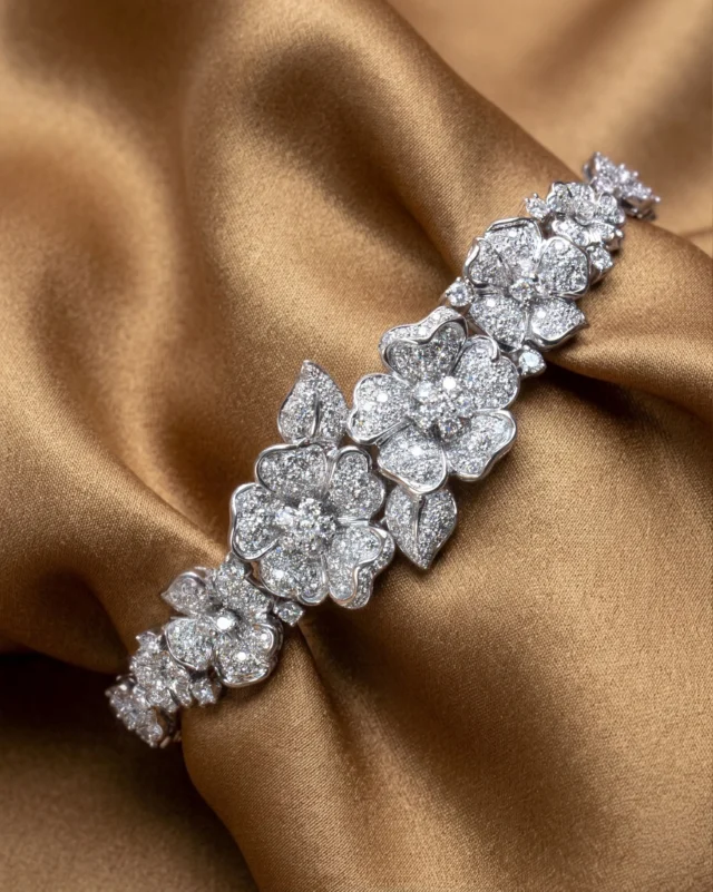 A garden on your wrist.
The Flora bracelet by Leo Pizzo is a procession of diamond flowers, each petal pavé-set in white gold, blooming one after the other in an endless dance of light. 
Not a jewel you wear — a jewel that wears the moment.

Collezione Flora 29580B